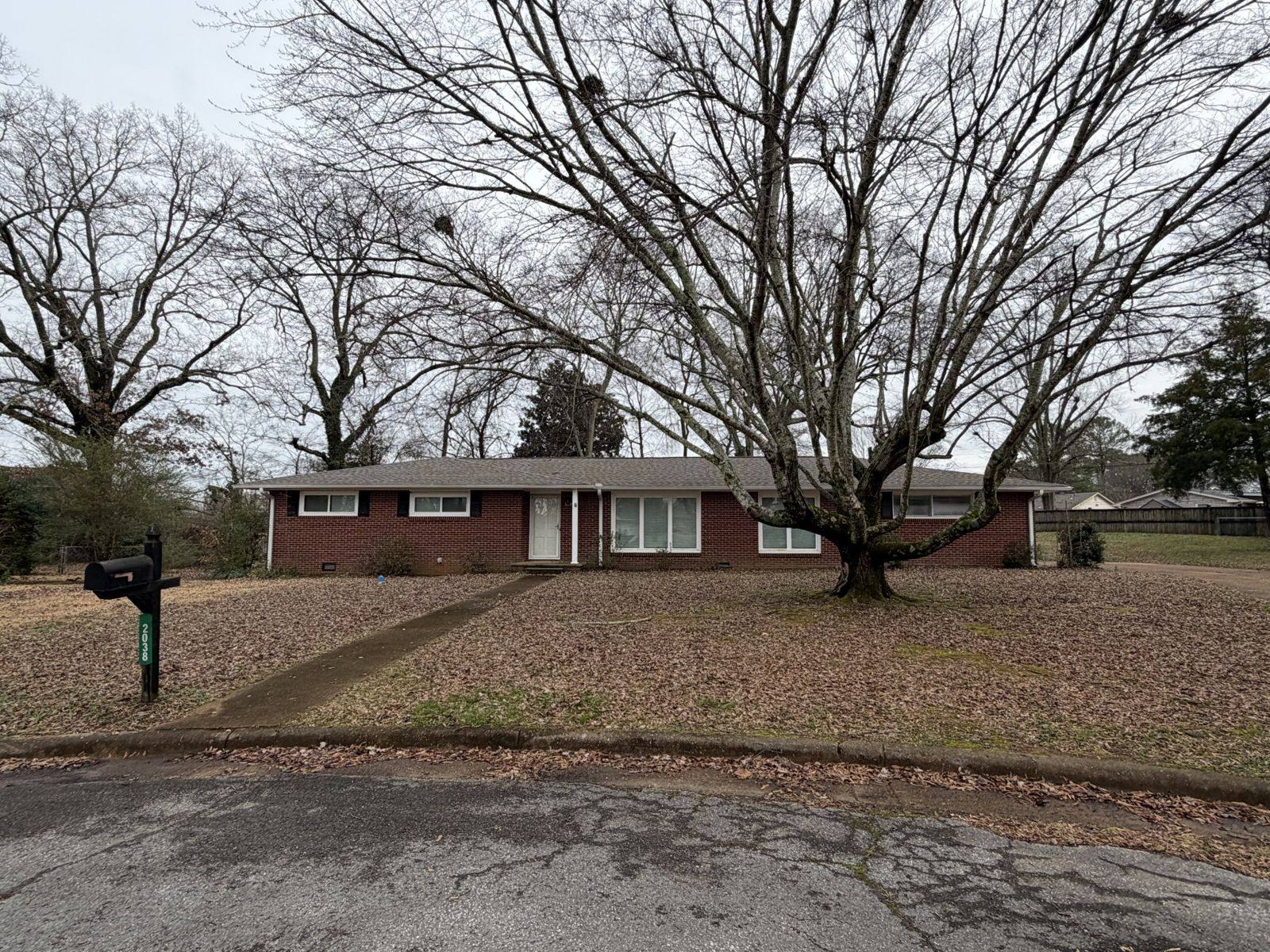 Brick ranch rental house on a wooded lot